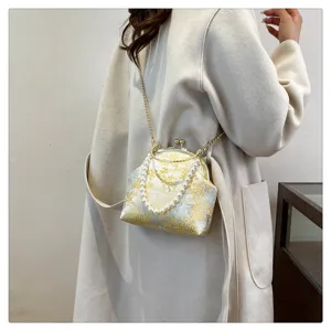 Detailed view of Chinese-style silk crossbody bag with pearls and floral patterns