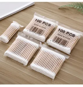 Detail shot of disposable double-headed wooden cotton swabs in clear 100pcs packaging.
