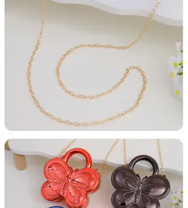 Detail view of trendy butterfly acrylic evening bag with metallic chain and glossy finish.