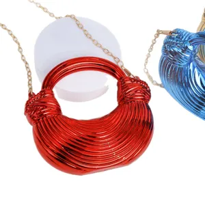 Glossy metallic acrylic dumpling handbag with gold chain strap, stylish evening bag.