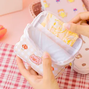Portable plaid sanitary napkin storage bag with cute cartoon pig, ideal for daily use.