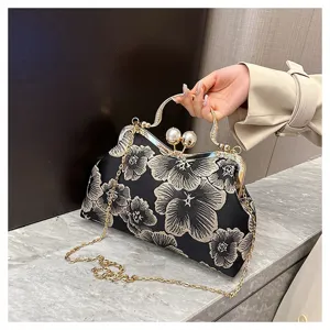 Detailed view of Chinese style floral embroidery handbag with pearl clasp and chain strap