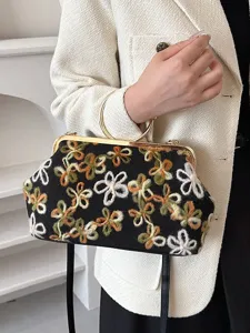 Vintage velvet handbag with floral embroidery and gold round handle for evening wear