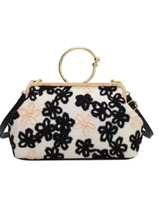 Vintage floral embroidery handbag with gold circular handle and shoulder strap.