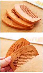 Peach wood comb detail shot showing fine teeth design and portable size for daily hair care.