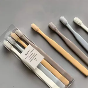 Detailed view of soft-bristled toothbrushes in pastel macaron colors, arranged for oral care.