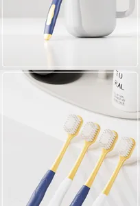 Detailed view of wide head soft toothbrush with dense bristles for adult gum care clean.