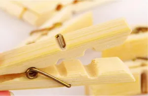 Natural bamboo clothespins with strong metal springs for household laundry and quilt drying use.
