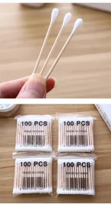 Detailed view of disposable wooden cotton swabs with double heads for daily cleaning and makeup use.