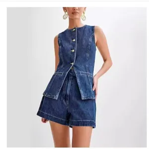 Detail view of women summer sleeveless denim vest and high-waisted shorts set in dark blue.