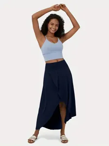 Detailed view of the stylish asymmetrical long skirt paired with a basic crop top.