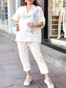 Casual white loose two-piece set featuring a half-sleeve top and trousers for women.