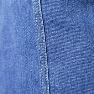 Close-up detail of blue denim fabric featuring durable double yellow stitching texture.