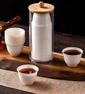 Disposable rice husk tea cups set with clear dispenser and wooden lid for Kung Fu tea.