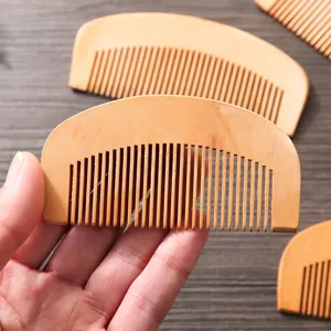 Portable peach wood fine tooth massage hair comb, compact and smooth pocket wooden hair comb.