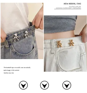 Close-up detail of cute bear-shaped waist tightener pin for jeans, metal decorative button accessory.
