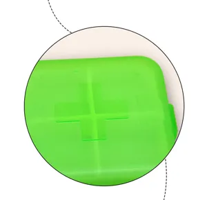 Detailaufnahme einer tragbaren grünen transparenten Kunststoff-Pillenbox mit Kreuz.