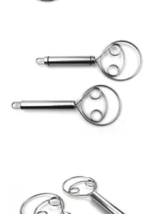 Stainless steel dough whisk detail showing coil design and metal handle for baking.