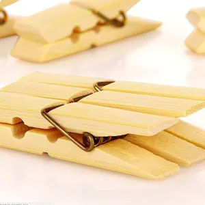 Natural bamboo clothespins with strong metal springs for secure daily clothes drying.