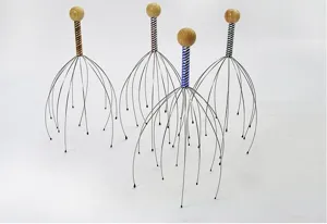 Gros plan sur les masseurs de tete en fil metallique avec poignees colorees en bois.