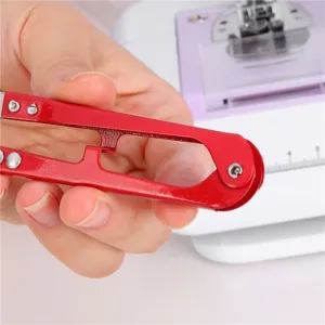 Red U-shaped embroidery scissors for thread clipping and sewing crafts, mini handheld tool.