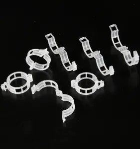 Detailed view of transparent plastic plant fixing clips and clips for supporting vines and tomatoes.