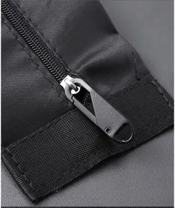 Close-up detail of black alloy detachable zipper puller on durable fabric strap for bags and apparel.