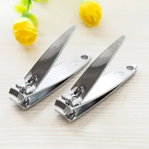 Stainless steel nail clipper detail shot showing sharp blade and polished handle surface.