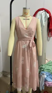 Pink floral V-neck sleeveless wrap dress detail showing the elegant digital print and waist tie.