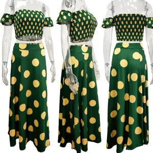 Green off-shoulder crop top and long skirt set detail showing polka dot print and smocked design.