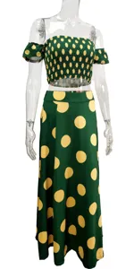 Detailed view of the green and yellow polka dot strapless top and long skirt set.