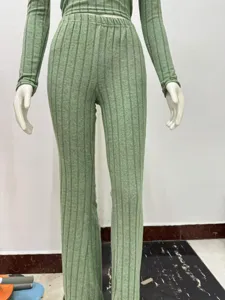 Detailed view of women green ribbed long sleeve top and pants set, soft stretchy knit fabric.