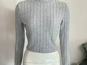Grey ribbed long sleeve knit top detail shot, soft texture and slim fit design for daily wear.