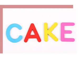 Detail of colorful wooden letters spelling CAKE for educational kids crafts and toys.