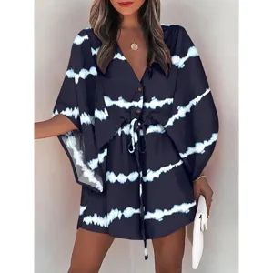 Detailed view of women's v-neck tie-dye beach dress with batwing sleeves and drawstring waist.