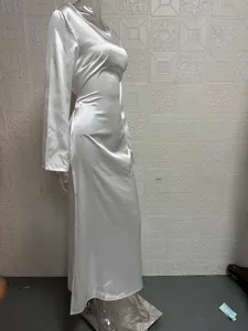 Detailed view of elegant white satin long sleeve maxi dress, smooth fabric texture and drape.