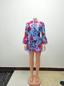 Close-up detail of the floral print dress featuring a half-open collar and bell sleeves.