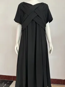 Detail view of a solid black short sleeve maxi dress with elegant cross front design.