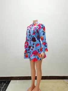 Blue floral print long sleeve tiered dress with half collar, elegant street style detail shot.
