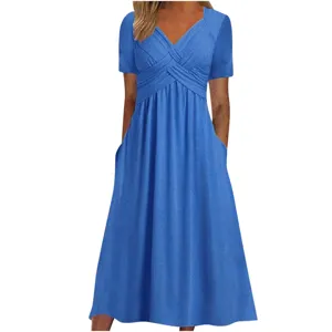 Detail shot of the blue short sleeve dress showcasing cross V-neck and pockets.