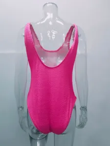 Fluorescent pink crinkle one-piece swimsuit with scoop back, textured stretch fabric detail.
