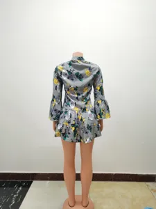 Back view detail of women vintage floral print mini dress with long bell sleeves and tier hem.