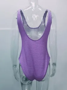 Women's purple crinkle one-piece swimsuit, backless candy color textured swimwear detail.