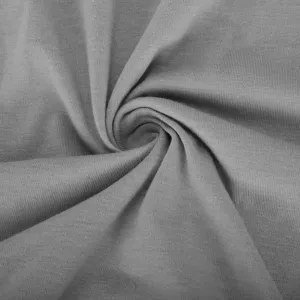 Grey knit dress fabric detail texture closeup showing soft material and natural swirl folds.