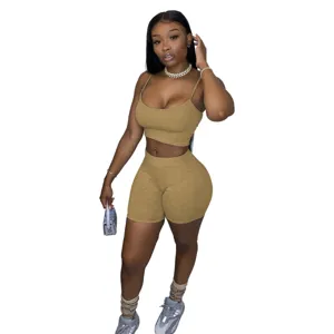 Stylish women two piece crop top and biker shorts set casual outfit for daily wear or sports.