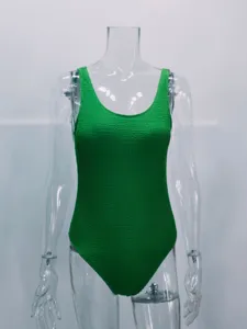 Detailed close-up view of the green crinkle one-piece swimsuit featuring textured fabric.