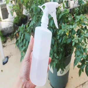 Close up detail view of the hand-pressed white plastic spray bottle nozzle used for indoor plants.