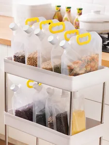Detailed view of clear stand-up spout pouches filled with various grains on a kitchen cart.
