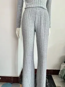 Grey ribbed knit two piece set featuring long sleeve top and flare pants for women.