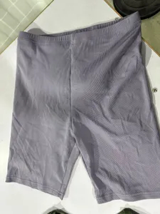 Close-up detail shot of casual ribbed biker shorts in soft purple, comfortable elastic waist.